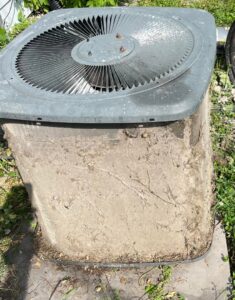 A heavily soiled outdoor air conditioning unit, highlighting the need for professional HVAC cleaning and maintenance from Greenley Heating & Cooling in Waterloo, IA