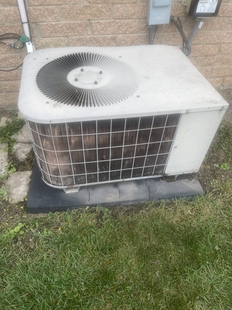 A dirty outdoor air conditioning unit, ready for service by Nimmer Heating & Air Conditioning in Milwaukee, WI