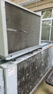 A dirty outdoor HVAC coil needing cleaning from Will Power Refrigeration Co, your contractor in Yonkers, NY.