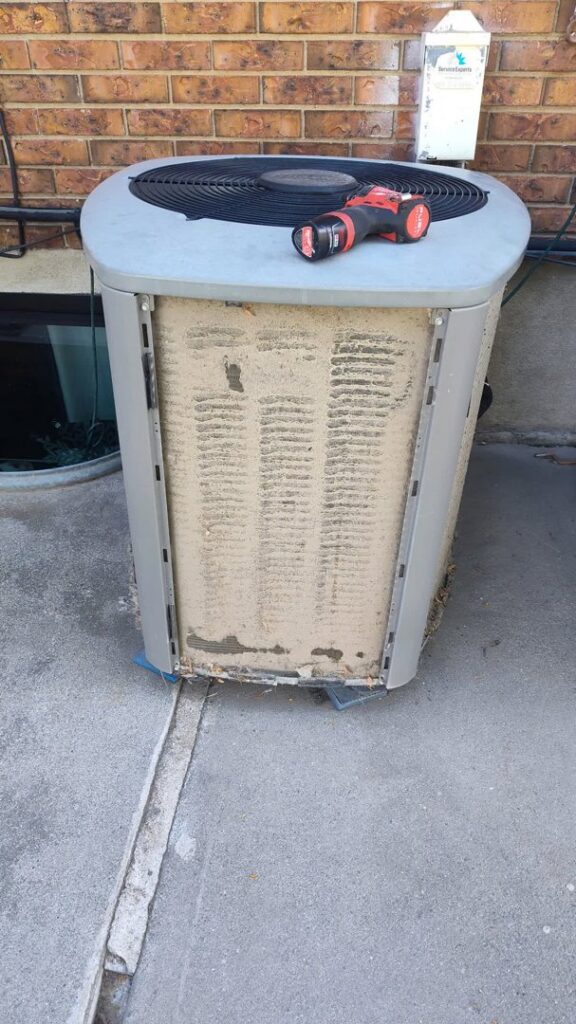A very dirty outdoor HVAC condenser unit in need of cleaning by APEX Clean Air in South Salt Lake, UT.