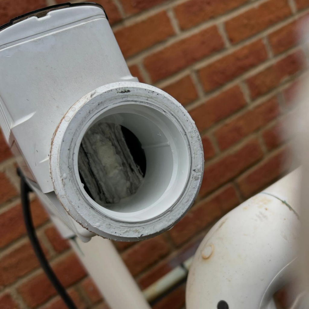 A close-up of a dirty pool chlorinator requiring maintenance from Hot Springs Pool Service in Chula Vista, CA.