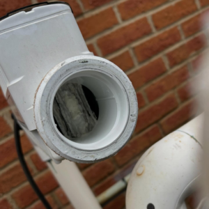 A close-up of a dirty pool chlorinator requiring maintenance from Hot Springs Pool Service in Chula Vista, CA.