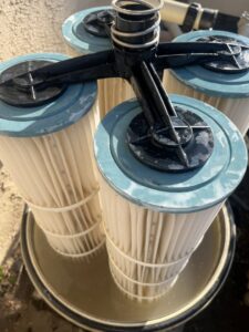Dirty pool filter cartridges removed for cleaning or replacement, a service provided by Good Guy Pool Service in Moreno Valley, CA.
