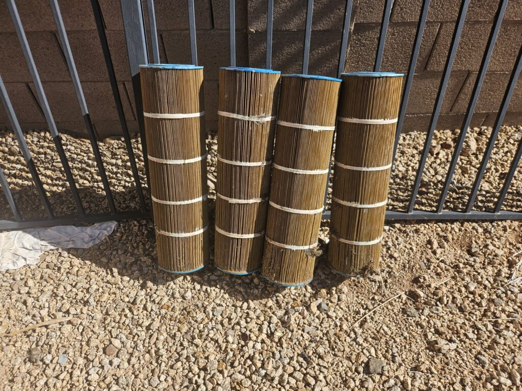 Dirty pool filter cartridges removed during a cleaning service by Vanguard Pool Care in Phoenix, AZ