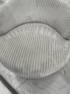 A close-up of a dirty ribbed upholstered chair being cleaned by White Diamond Carpet Cleaners in Baton Rouge, LA.