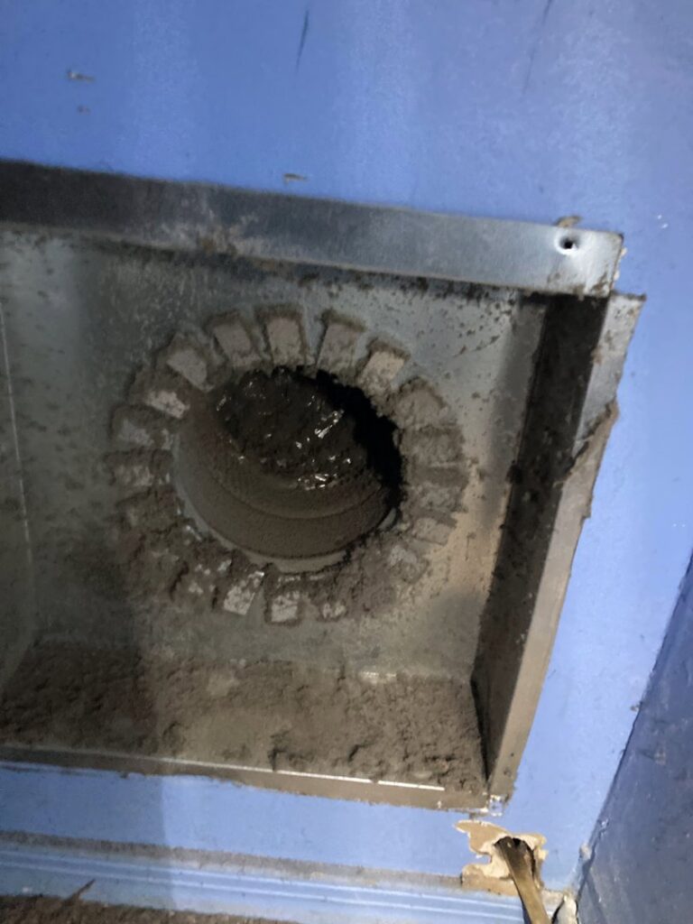 A dirty round air duct opening with visible mold or heavy dust accumulation, requiring cleaning by Star Quality Air Duct Cleaning in Silver Spring, MD.