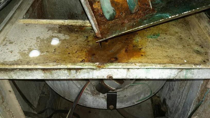 A dirty and rusty HVAC coil and drain pan needing service from Purair Hawaii in Honolulu, HI.