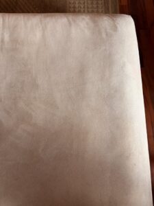 A close-up of a dirty sofa cushion, indicating upholstery cleaning services by Heaven's Best Carpet Cleaning San Diego CA.