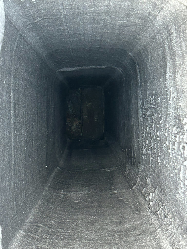 An interior view of a dirty, soot-covered chimney flue during an inspection by Soot Busters in Birmingham, AL.
