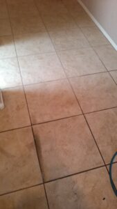 A tiled floor with visible dirt and grime in the grout lines, ready for cleaning by A Copesetic Carpet, Upholstery, Tile & Grout Cleaner in Mesa, AZ