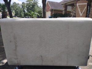 A dirty, stained upholstered bench cushion before cleaning by Tex A Clean Carpet Care in League City, TX.