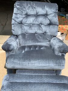 A dirty upholstered recliner chair before professional cleaning by Elementscarpetcleaning.net in Omaha, NE.