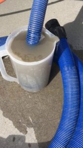 A pitcher of dirty water extracted from carpet cleaning, showing results from Kung Fu Carpets and Cleaning Co. in Meridian, ID.