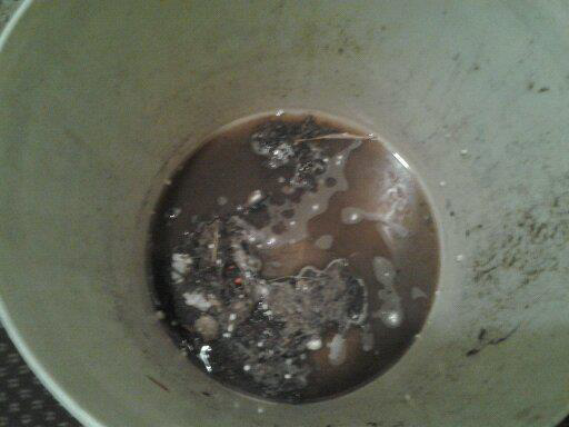 A bucket of dirty water extracted during a professional carpet and tile cleaning job by Awesome Carpets in Elk Grove, CA.