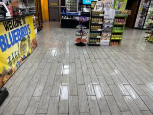 A dirty, wet tile floor in a convenience store, ready for cleaning by Great Day Carpet & Tile Cleaning LLC Desoto in Olive Branch, MS.