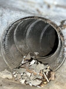 The interior of a very dirty wooden air duct in need of cleaning by APEX Clean Air in South Salt Lake, UT.