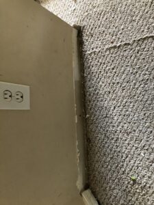 Close-up of a dirty and worn carpet edge next to a wall, showing need for service from Fresh Step Cleaning Services in Owensboro, KY
