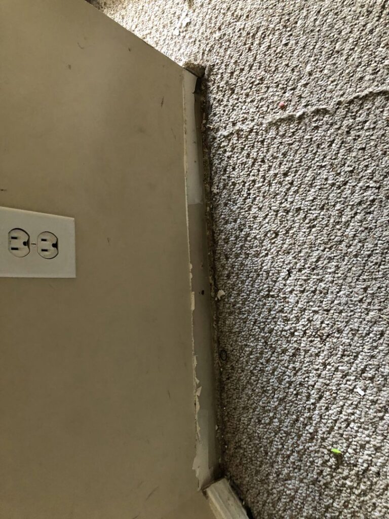 Close-up of a dirty and worn carpet edge next to a wall, showing need for service from Fresh Step Cleaning Services in Owensboro, KY