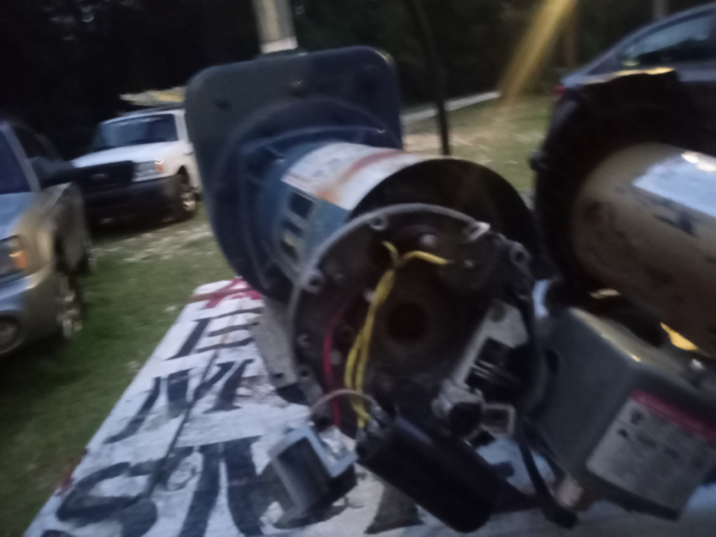 A disassembled electric motor or pump undergoing repair at All Seasons Electric Motor and Small Engine Repair in Fayetteville, NC.