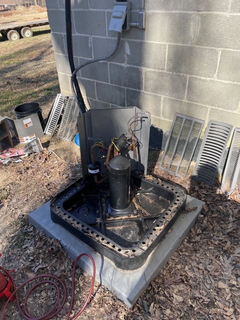 A dismantled old outdoor HVAC unit being prepared for removal by Ave Heating & Air LLC in Douglasville, GA.