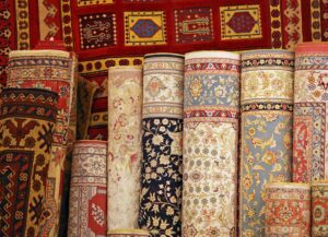 A vibrant display of various rolled oriental rugs and carpets, showcasing inventory at Carpet Cleaner Staten Island in Staten Island, NY.