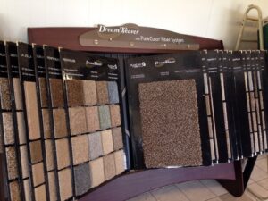 A showroom display featuring various carpet samples for selection at Home Dynamics Flooring LLC in Harrisburg, SD.