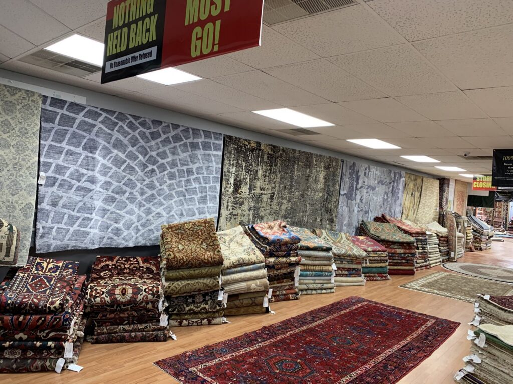 A diverse collection of area rugs and carpets displayed for sale at Khazai Rugs in Lexington, KY