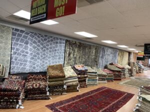 A diverse collection of area rugs and carpets displayed for sale at Khazai Rugs in Lexington, KY
