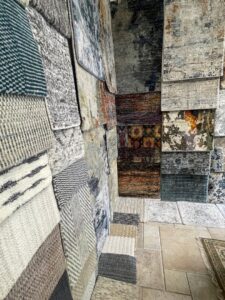 A diverse selection of rug and carpet samples displayed in the showroom at Rugs By Design in Castleton, IN