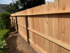 A close-up view of a dog-ear style wood privacy fence, expertly installed by The Fence Company in Fresno, CA.