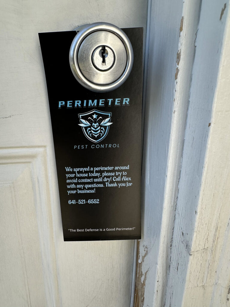 A door hanger from Perimeter Pest Control DSM left after a pest control service in Des Moines, IA, informing the homeowner about the treatment.