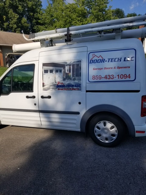 A Door-Tech LLC service van parked at a job site, ready to provide garage door services in Lexington, KY.