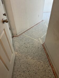A doorway leading to a room with newly installed light brown carpet by First Quality Carpets Inc. in Orlando, FL