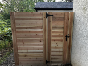 A custom double gate made of horizontal wood slats, installed by CDM Home Solutions in Columbus, OH.
