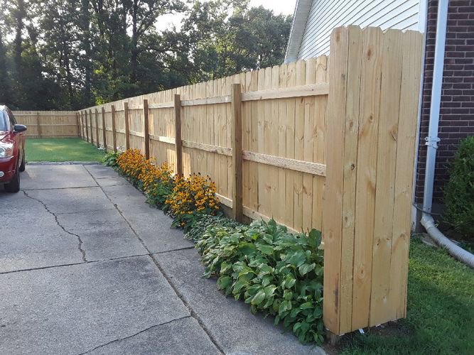 Double white vinyl gates installed at the end of a residential driveway by Best Fence & Gate LLC in Louisville, KY.