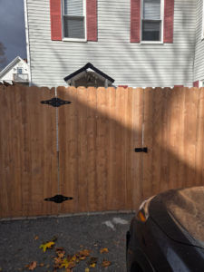A double wooden privacy gate installed in a residential area by Dore's Fence Company in Greenbush, ME.
