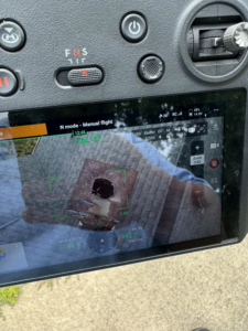 Drone screen showing roof damage inspection for wildlife control by DefendPro Pest Solutions in Rushville, IL.