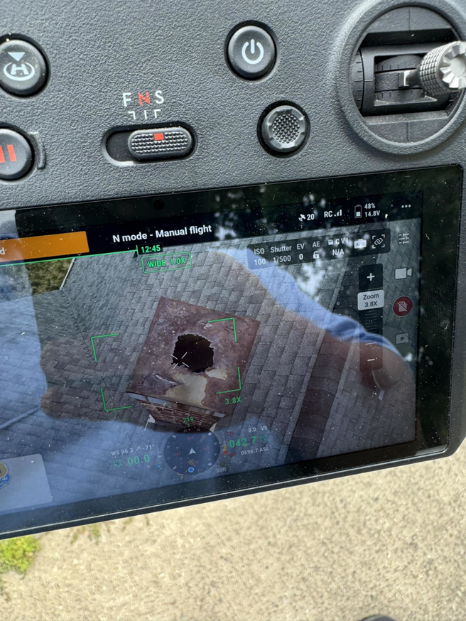 Drone screen showing roof damage inspection for wildlife control by DefendPro Pest Solutions in Rushville, IL.