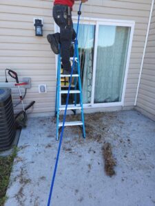 HVAC technician performing dryer vent cleaning, showing removed lint, by Duct Pros in Martinsburg, WV