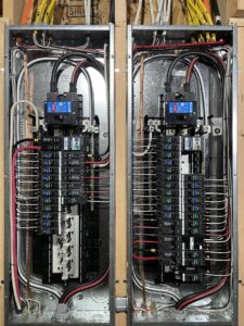 Two newly installed electrical breaker panels with organized wiring by Kot Electric LLC in Kent, WA.