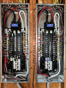 Two newly installed electrical breaker panels with organized wiring by Plugz Electric LLC in Forest Lake, MN