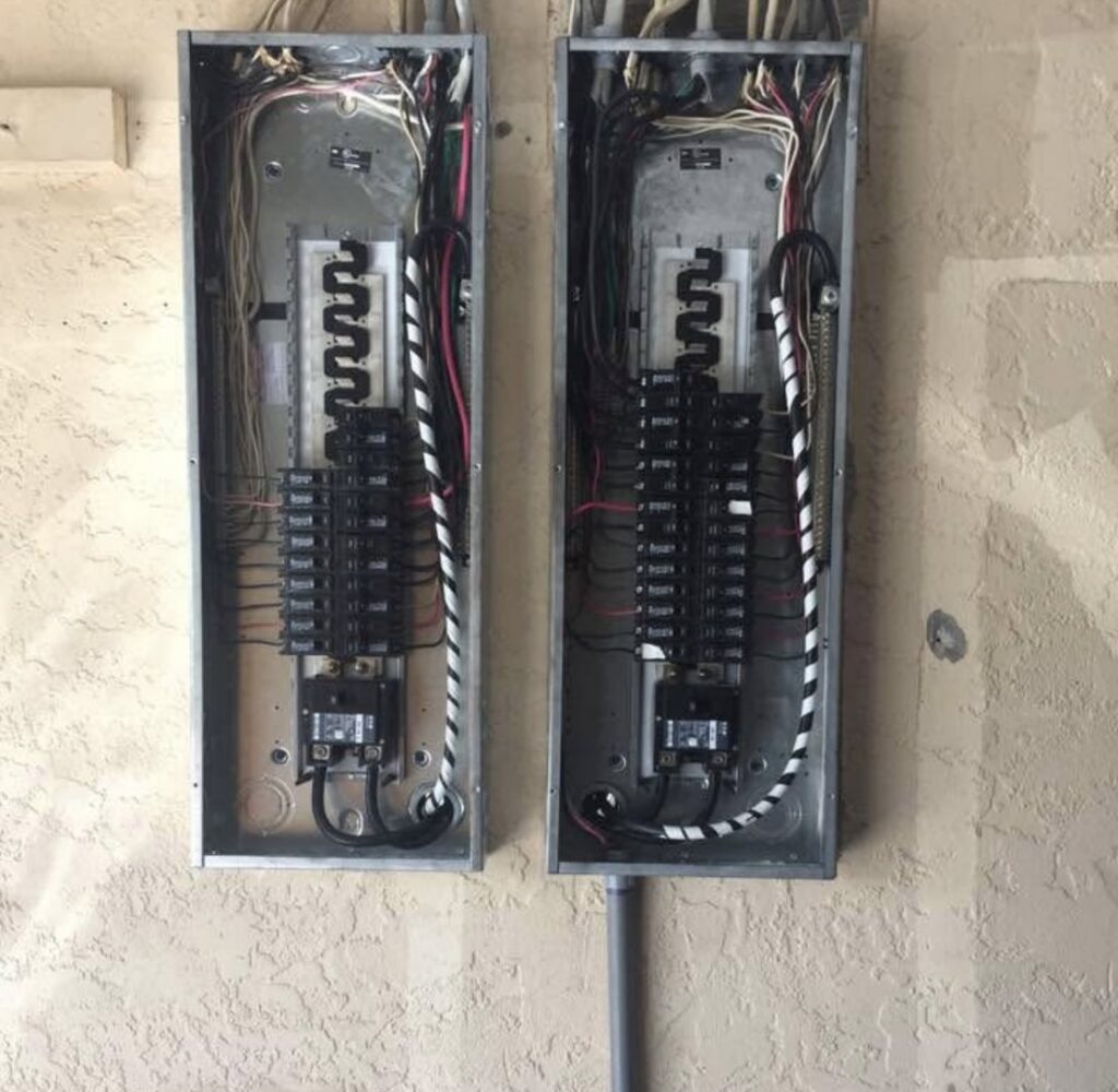 Dual electrical panels with intricate wiring and circuit breakers installed by Ryno Electric in Cape Coral, FL