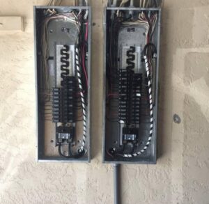Dual electrical panels with intricate wiring and circuit breakers installed by Ryno Electric in Cape Coral, FL