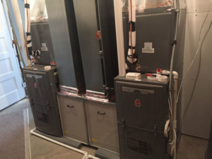 Two indoor furnace units installed side-by-side by Extreme Heating & Cooling in Beaver Dam, KY