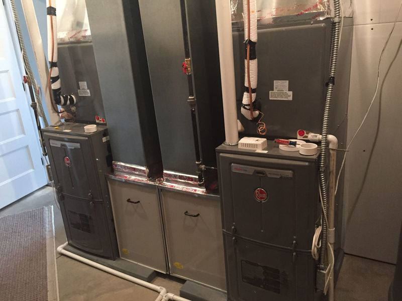 Two indoor furnace units installed side-by-side by Extreme Heating & Cooling in Beaver Dam, KY