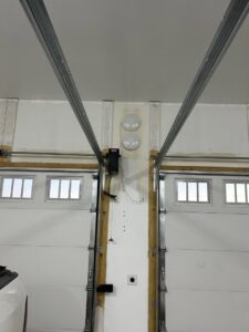 An interior view of a dual garage door system undergoing inspection or service by SS Garage Door Repair in Denver, CO.
