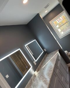 Dual LED-lit mirrors and recessed lighting installed in a modern bathroom by Breakers Electric LLC in Dover, NH.