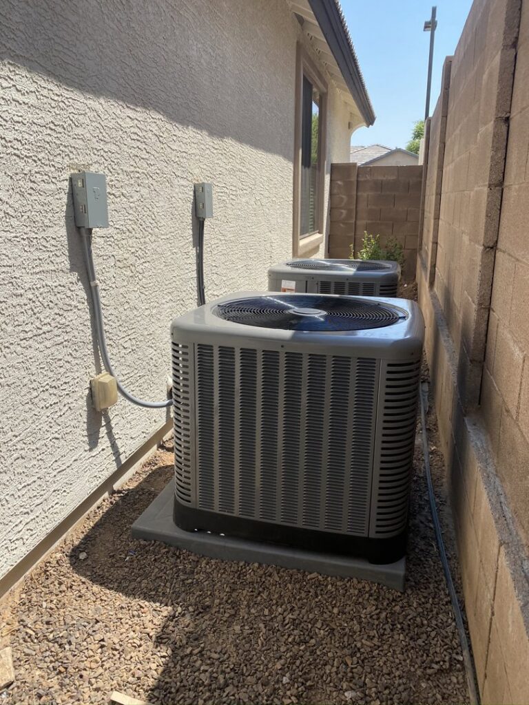 Dual outdoor AC units installed next to a house by Kings of AC, LLC in Queen Creek, AZ.