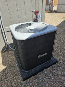 A Ducane outdoor air conditioning unit installed next to a residential building by Colton Air Conditioning - Las Vegas in Las Vegas, NV.