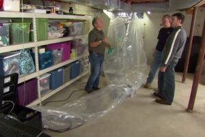 Technicians setting up duct sealing and testing equipment in a residential basement for Aspen Air Duct Cleaning in Methuen, MA.